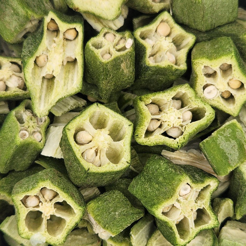Load image into Gallery viewer, Close-up of sliced green okra pods with seeds inside.
