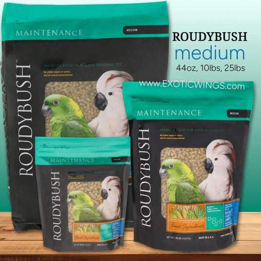 Three packages of Roudybush bird food for medium birds on a wooden surface with a teal background.